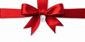 thoughtful gift for her with red bow and xo tag simple elegant presentation