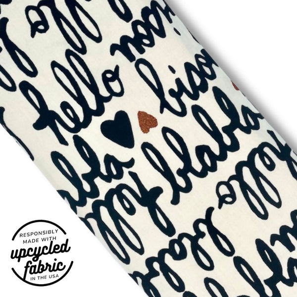 Close-up of French script and red glitter heart fabric on the Bisou Wand Pouch.