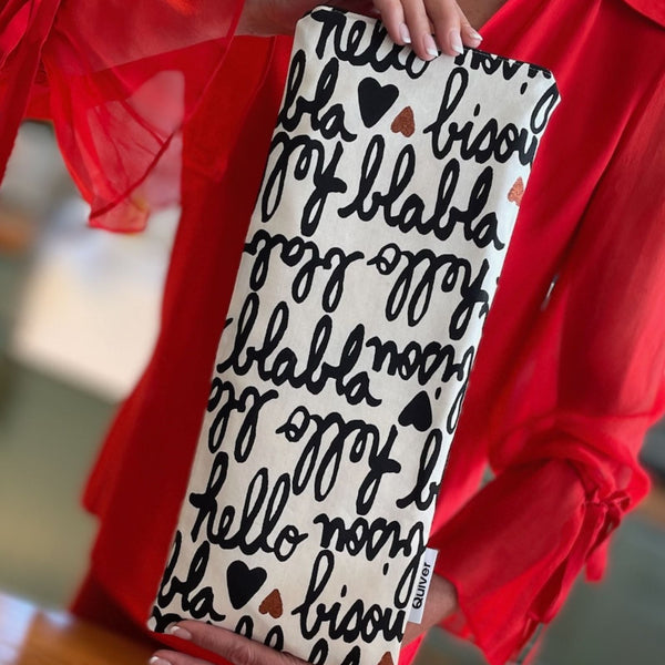 Lifestyle photo of the Bisou Wand Pouch styled on a nightstand or packed in a bag.