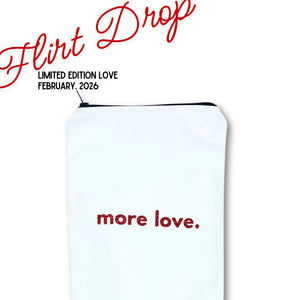 Original Wand Pouch in white denim with 'more love.' text  in red glitter and 'flirt drop' valentine day promotion branding on a white background