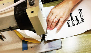 Hands sewing a Quiver.love Original Wand Pouch in Fall River, Massachusetts for discreet wand massager storage