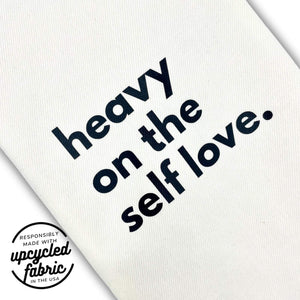 Wand pouch with “Heavy on the Self-Love” text printed on off-white denim fabric detail