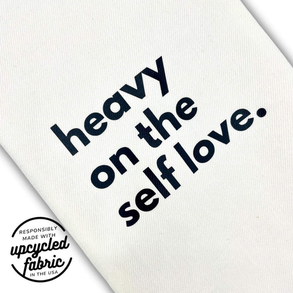 Wand pouch with “Heavy on the Self-Love” text printed on off-white denim fabric detail