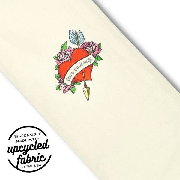 Original wand pouch with vintage flaming heart tattoo print on sueded off-white cotton, fabric and decal detail.  Embellishment reads "love yourself" and logo overlay highlights responsibly made in the USA of reclaimed fabrics
