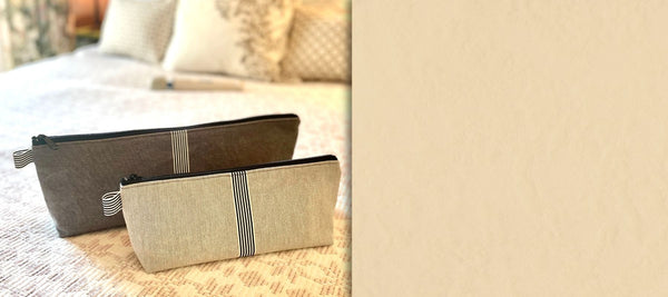 Wand pouch and vibe pouch on a bed in a bedroom setting for discreet personal wellness storage