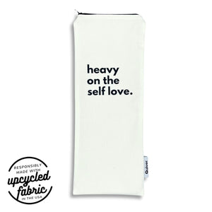 Wand pouch with “Heavy on the Self-Love” text printed on off-white denim.