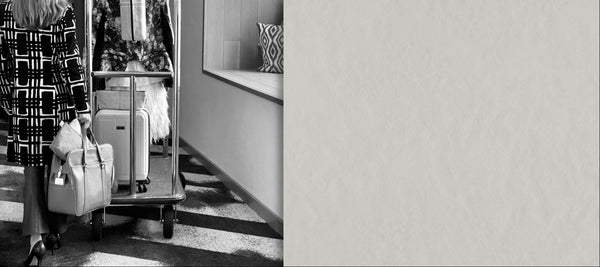 Woman walking through hotel hallway with luggage carrying wand massager storage pouch in travel bag