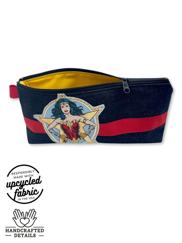 yellow cotton lining detail of vibrator, sex toy storage bag in denim with red ribbon and wonder woman patch
