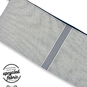 Fabric detail of sex toy pouch in pale neutral denim fabric with black and white ribbon accent, made in USA by Quiver.Love