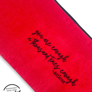 Fabric detail of sex toy pouch in cheery red fabric with black embroidery embellishment, made in USA by Quiver.Love